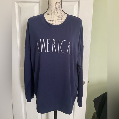 Rae Dunn lightweight sweatshirt in dark blue with word “AMERICA” on front.