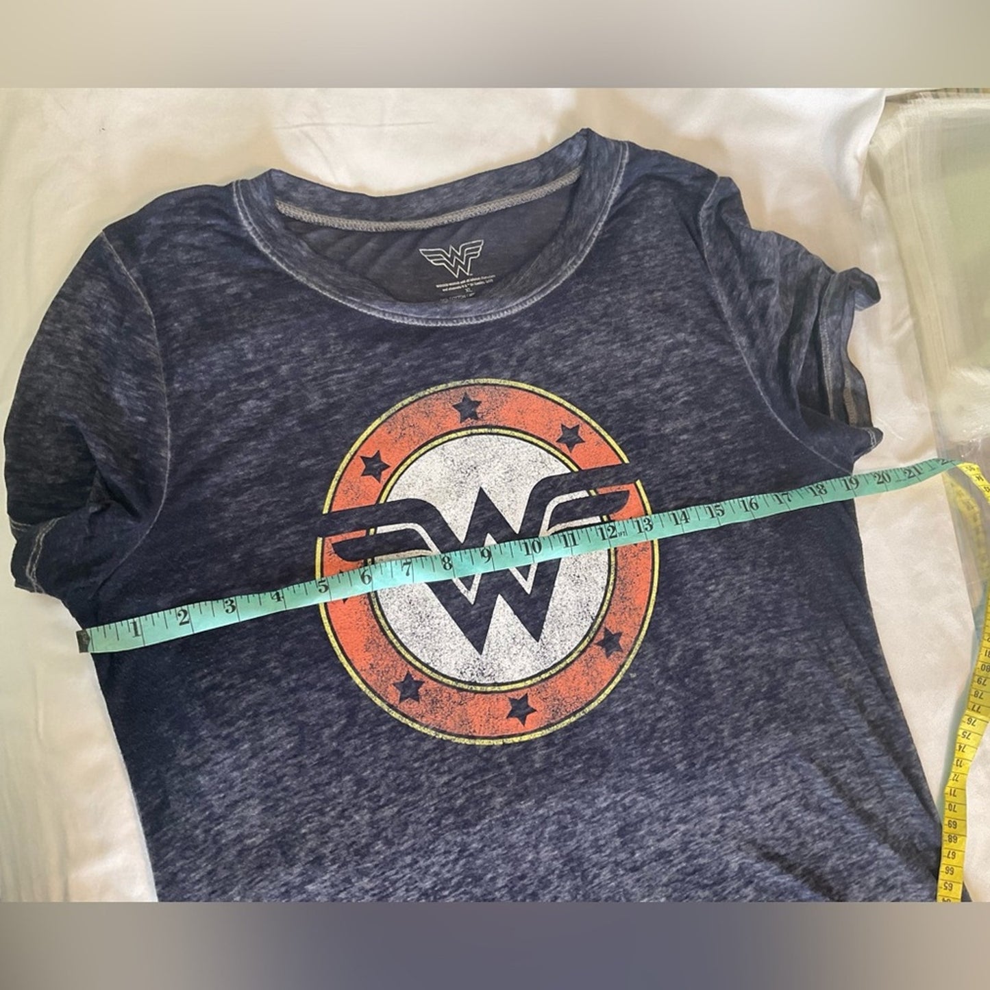 Wonder Woman short sleeve t-shirt in a blue color with the WW emblem.