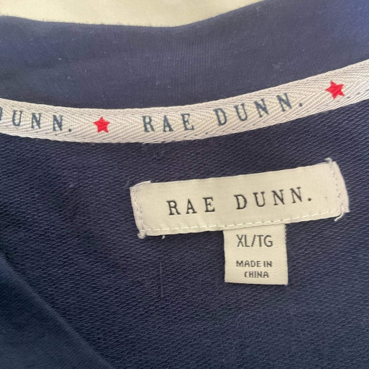 Rae Dunn lightweight sweatshirt in dark blue with word “AMERICA” on front.