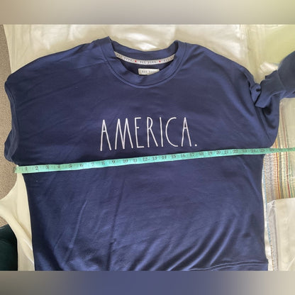 Rae Dunn lightweight sweatshirt in dark blue with word “AMERICA” on front.