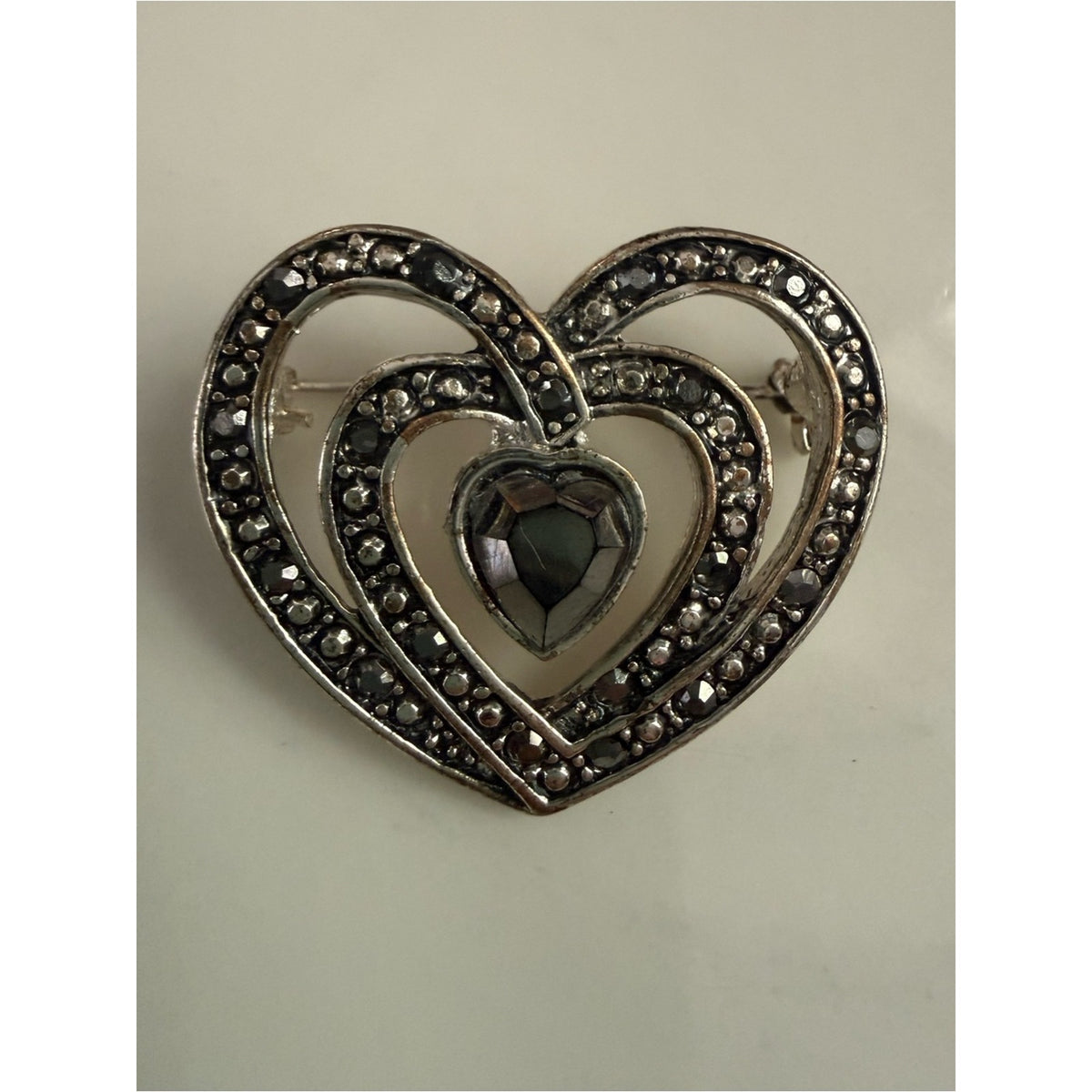 Vintage rhinestone Heart shape silvertone Filigree Brooch with gray/black Stones
